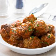 A dish full of Low Carb Italian Meatballs sprinkled with fresh parsley.