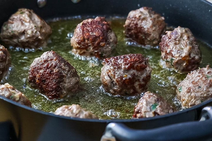 Browned meatballs in a pan