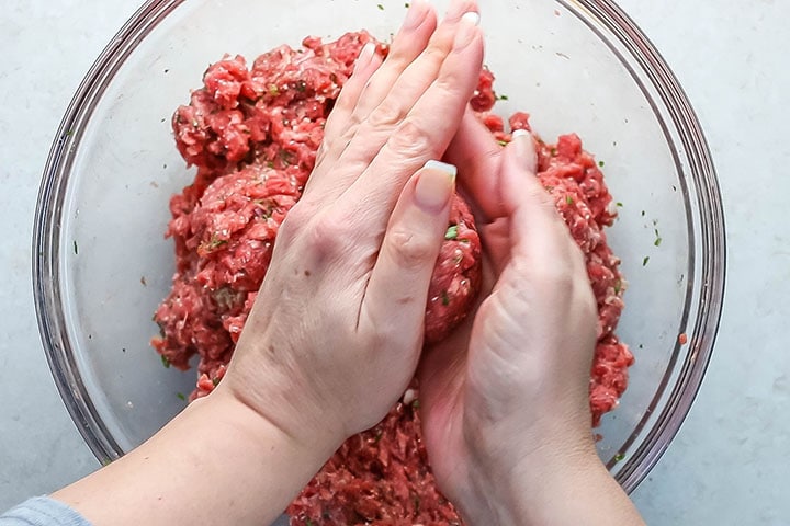 Hands rolling a meatball