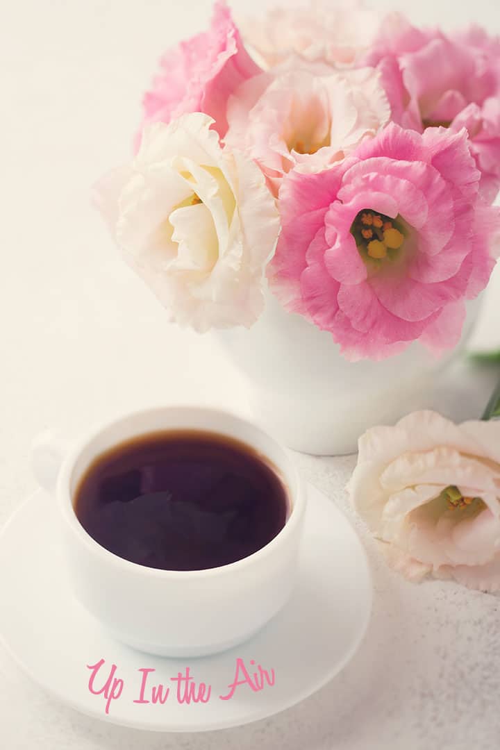 Still life with cup of coffee and flowers