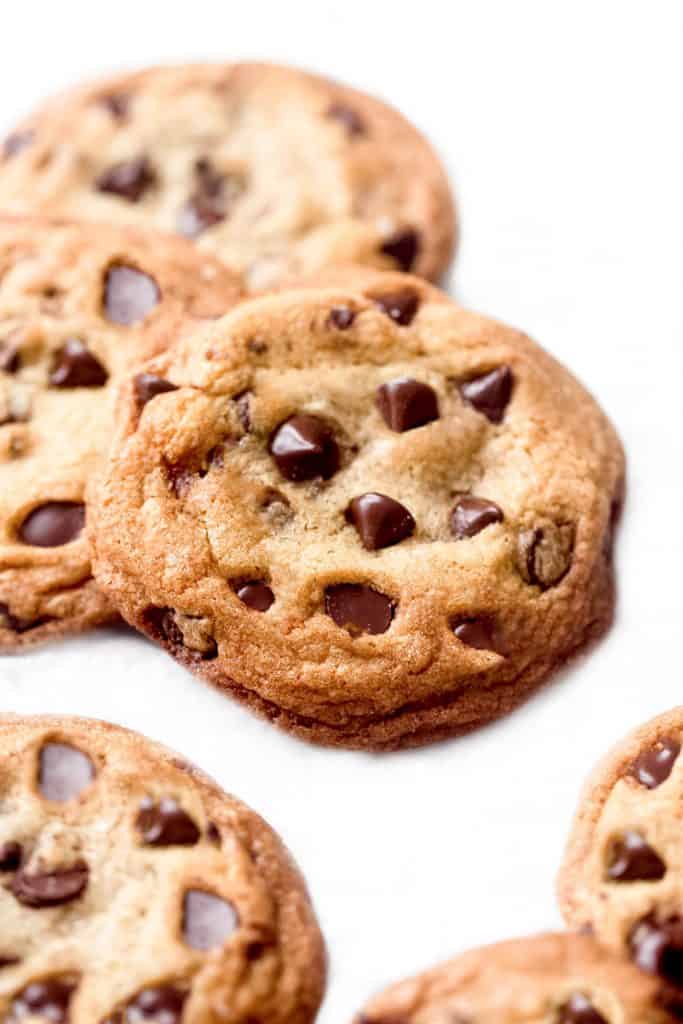chocolate chip cookies scattered on a white background
