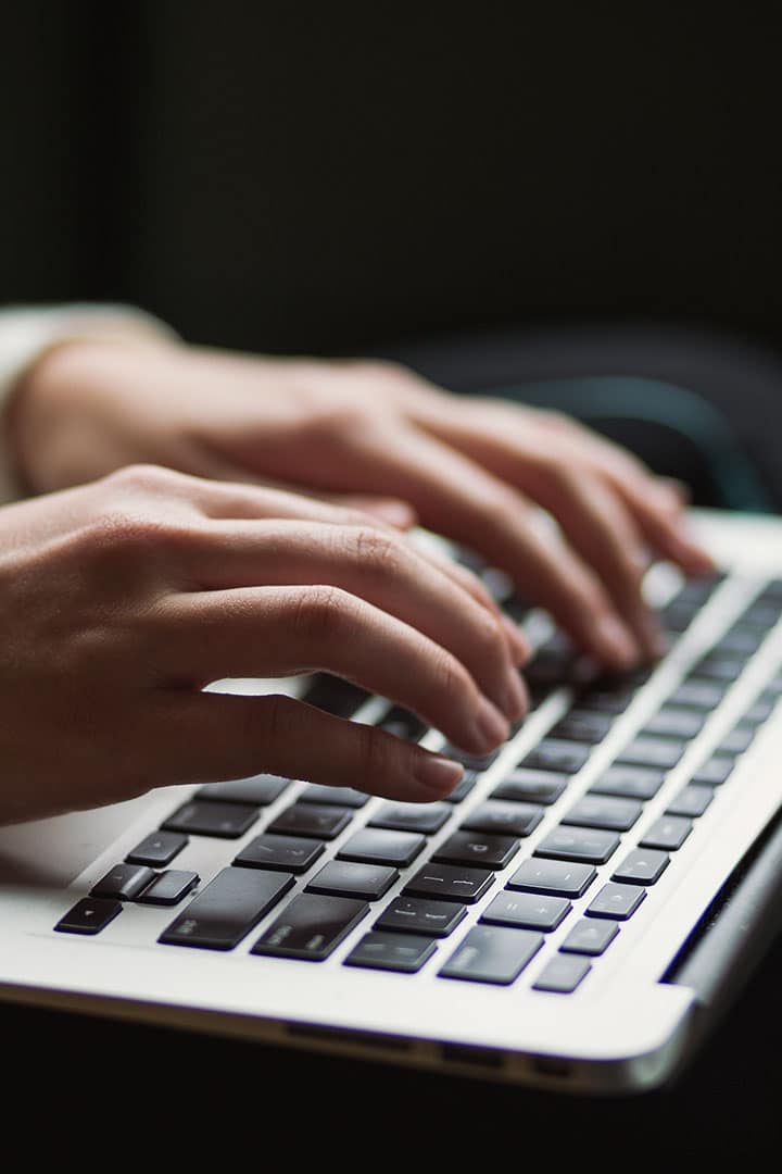 Hands typing on a keyboard