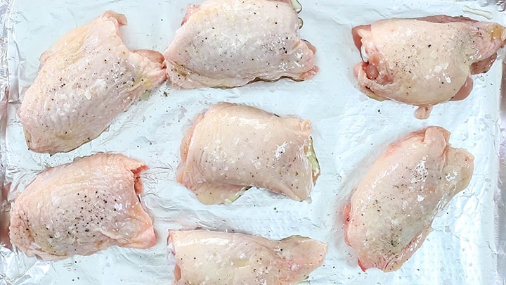 The chicken thighs seasoned with salt and pepper