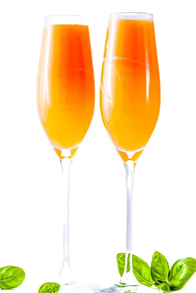 two mimosa cocktails with a white background