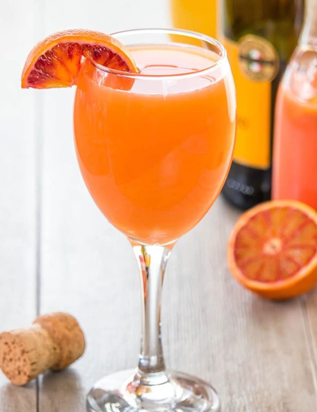 The Perfect Mimosa with a wedge of blood orange on the glass