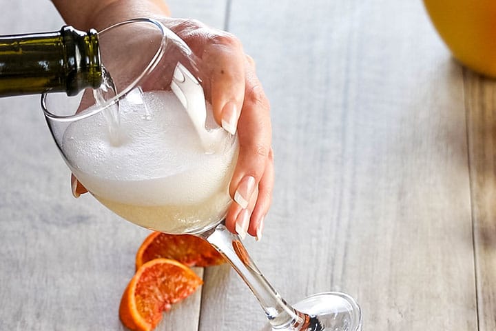Sparking wine being poured into a glass on a slant