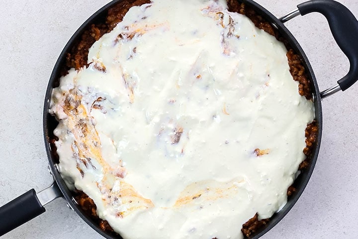 The topping spread over the layers in the pan.