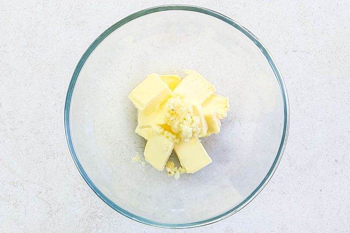 The garlic added to the butter in a bowl