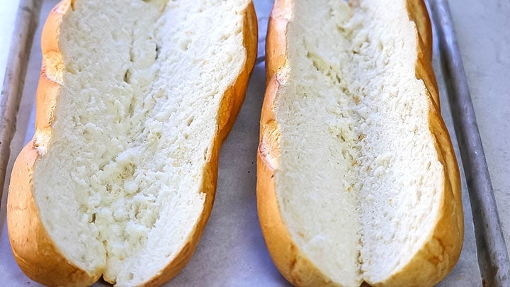 Two loaves of french bread cut down the center lengthwise 