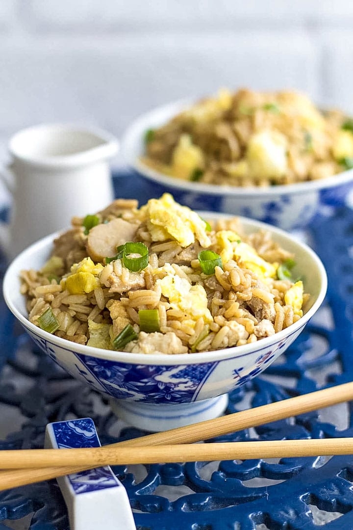 two bowls of fried rice and chopsticks