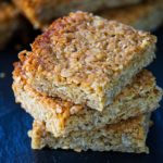 Classic British Flapjacks stacked on top of each other with more in the background