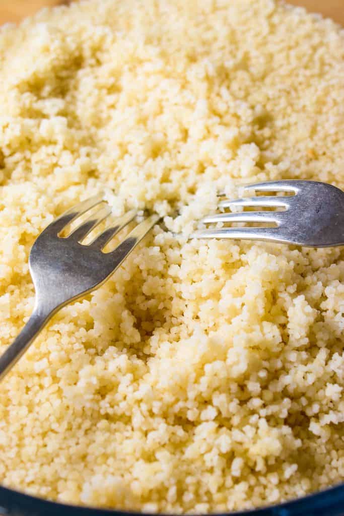 forks separating freshly cooked couscous
