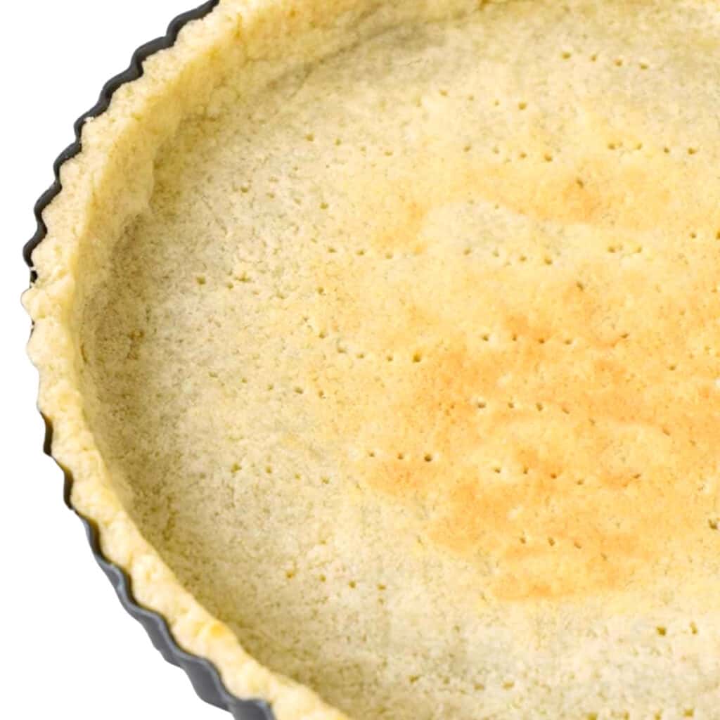 a partially baked pie crust in the pan