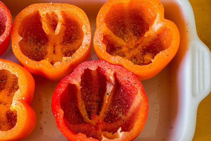 Coared peppers in a pan seasoned with salt and pepper