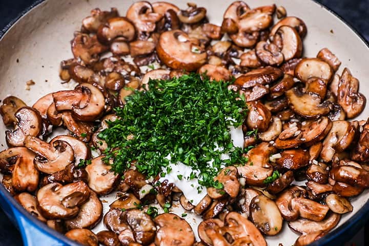 Sour Cream and parsley added to the pan with garlic and mushrooms