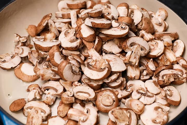 Raw sliced mushrooms in a pan