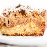 Crumb Coffee Cake piled high with crumb topping and topped with powdered sugar