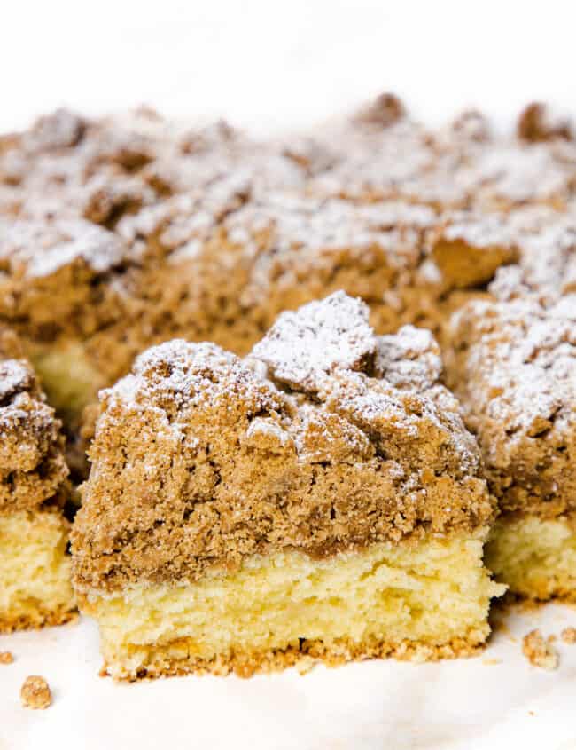 A Crumb Coffee Cake with a slice cut from it.