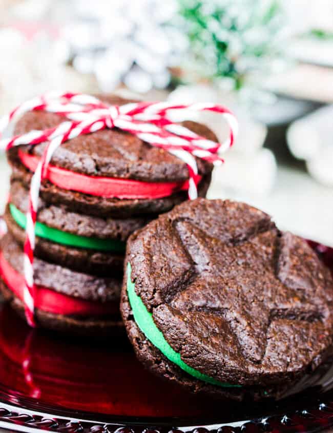 A stack of Christmas Oreo Cookies with one leaning against them