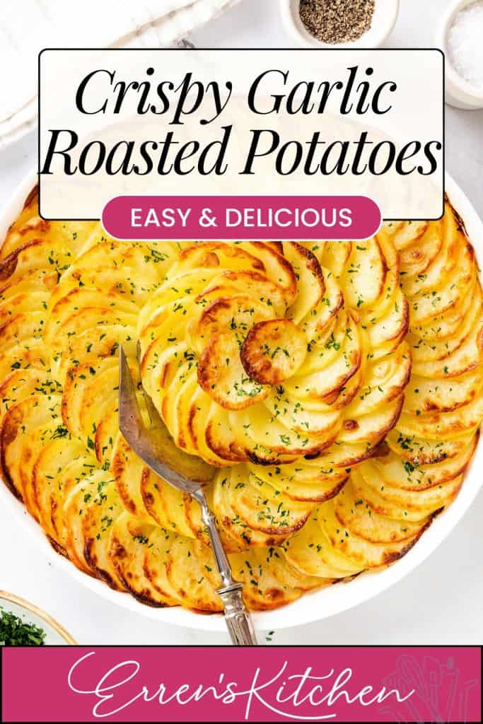 A round dish of Crispy Garlic Roasted Potatoes, thinly sliced and golden-brown, spiraled and topped with herbs. Text above reads: “Crispy Garlic Roasted Potatoes—Easy & Delicious.” A serving fork rests in the dish.