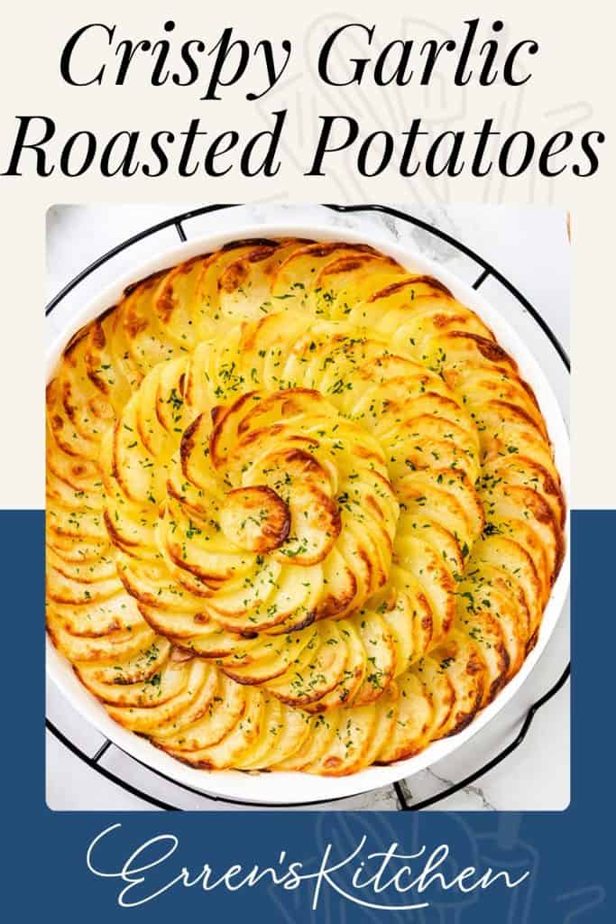 A round dish filled with thinly sliced, golden-brown Crispy Garlic Roasted Potatoes arranged in a spiral pattern, sprinkled with herbs. Text reads “Crispy Garlic Roasted Potatoes” and “Erren’s Kitchen.”.