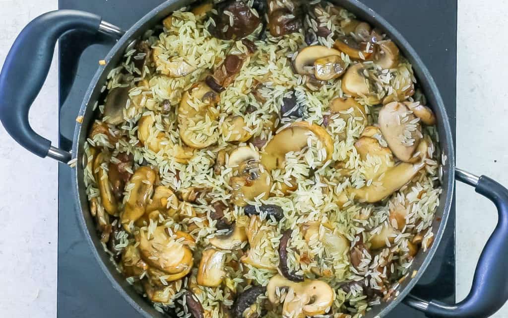 The rice added to the pan with the mushrooms