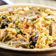 a close up of easy mushroom rice pilaf in a serving dish