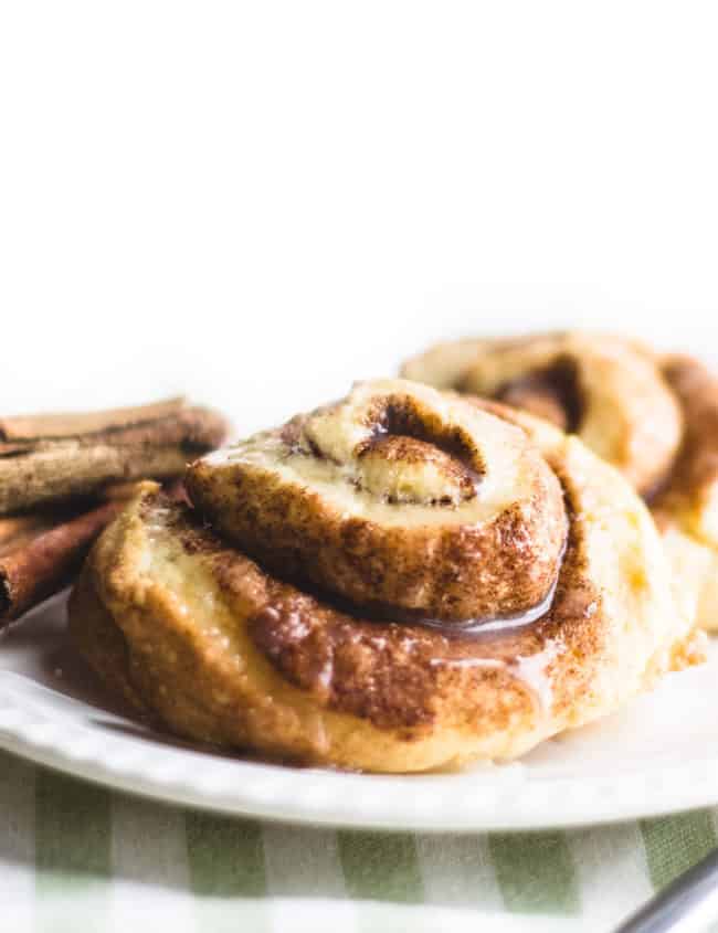 Cinnamon Swirl Scones on a plate with cinnamon sticks