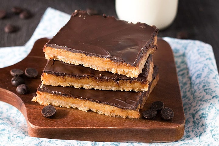 three Toffee pars stacked on top of eachother with a little bottle of milk in the background