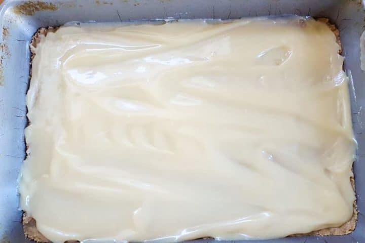 The condesned milk mixture spread over the base layer