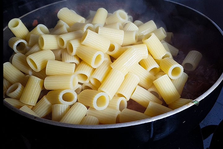pasta added to the pan with the sauce