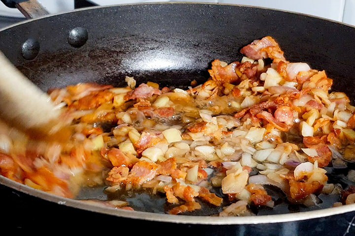 The wine cooking with the onions in the pan