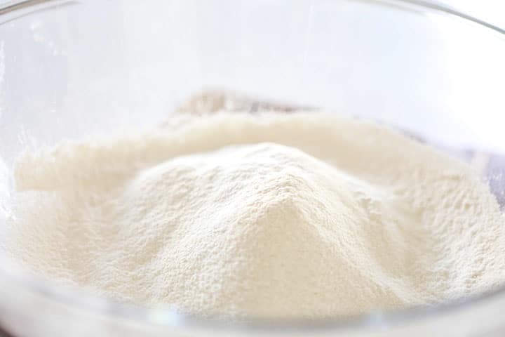The flour in a glass mixing bowl