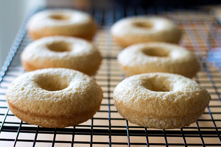 the freshly Baked Vanilla Donuts cooling on a cooling rack