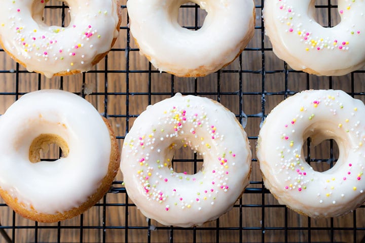 iced Baked Vanilla Donuts cooling on a cooling rack