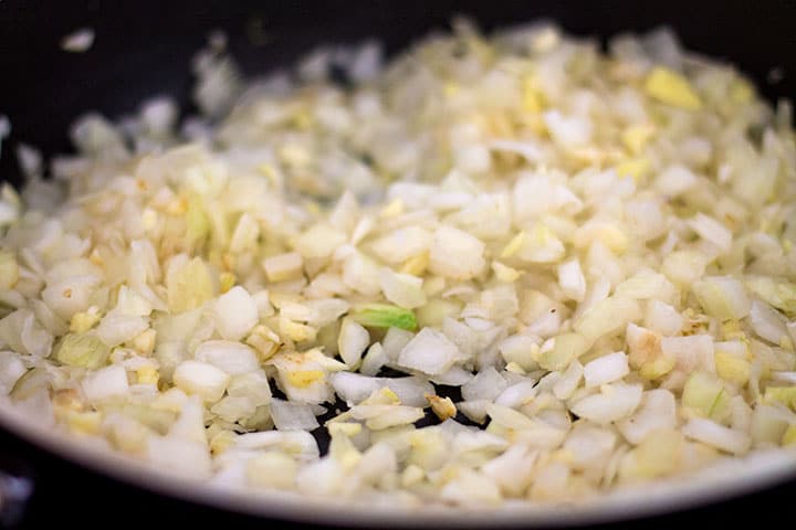 Onions and garlic cooking in a pan