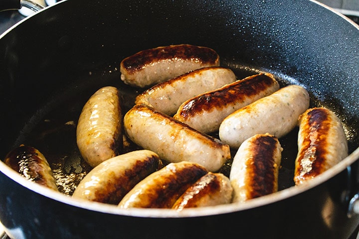 Italian sausage browning in a pan