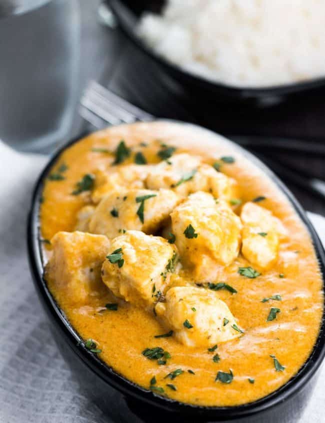Chicken Korma in a serving dish sprinkled with fresh corriander