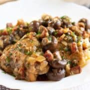 Chicken with Sherry Mushrooms Sauce piled high on a white plate