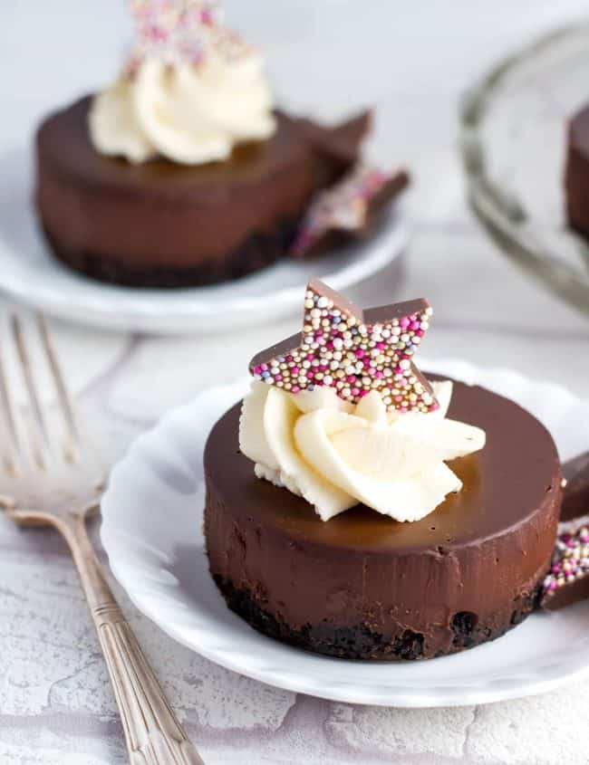 A choclate dessert topped eith whipped cream and a chocolate star