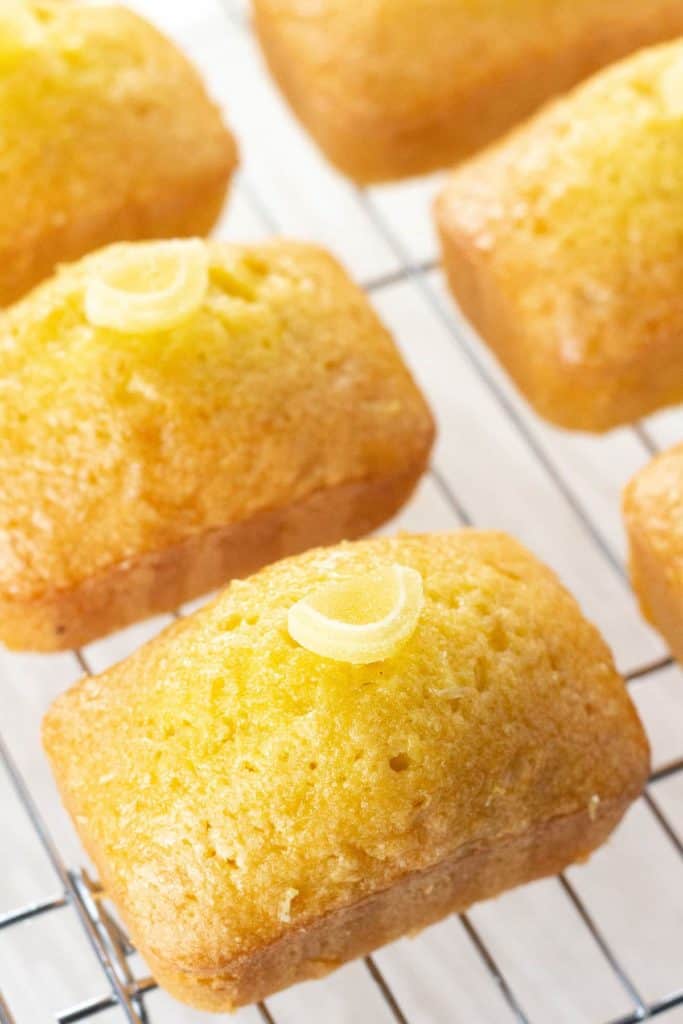 mini lemon drizzle cakes on a cooling rack