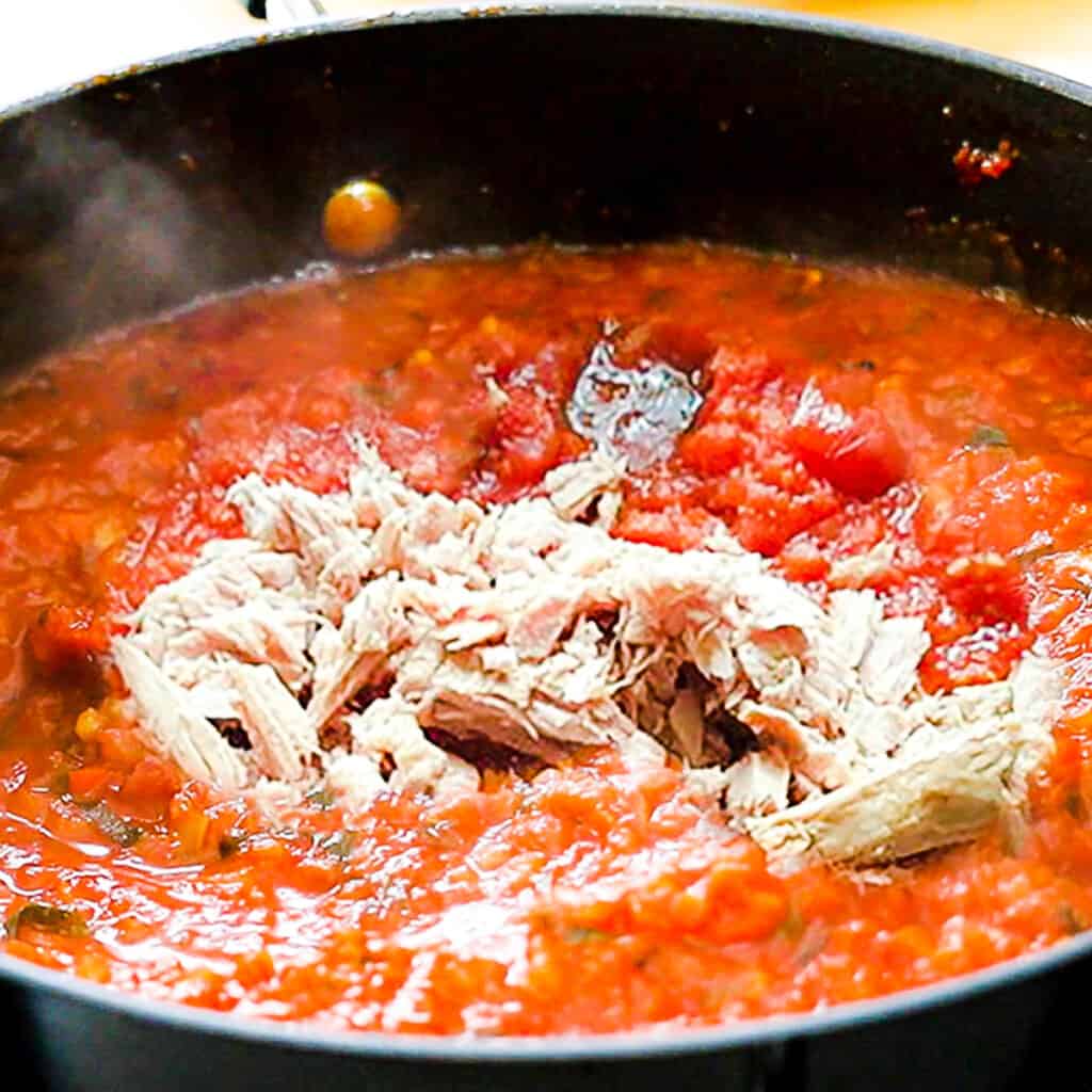 drained canned tuna added to the sauce in the pan