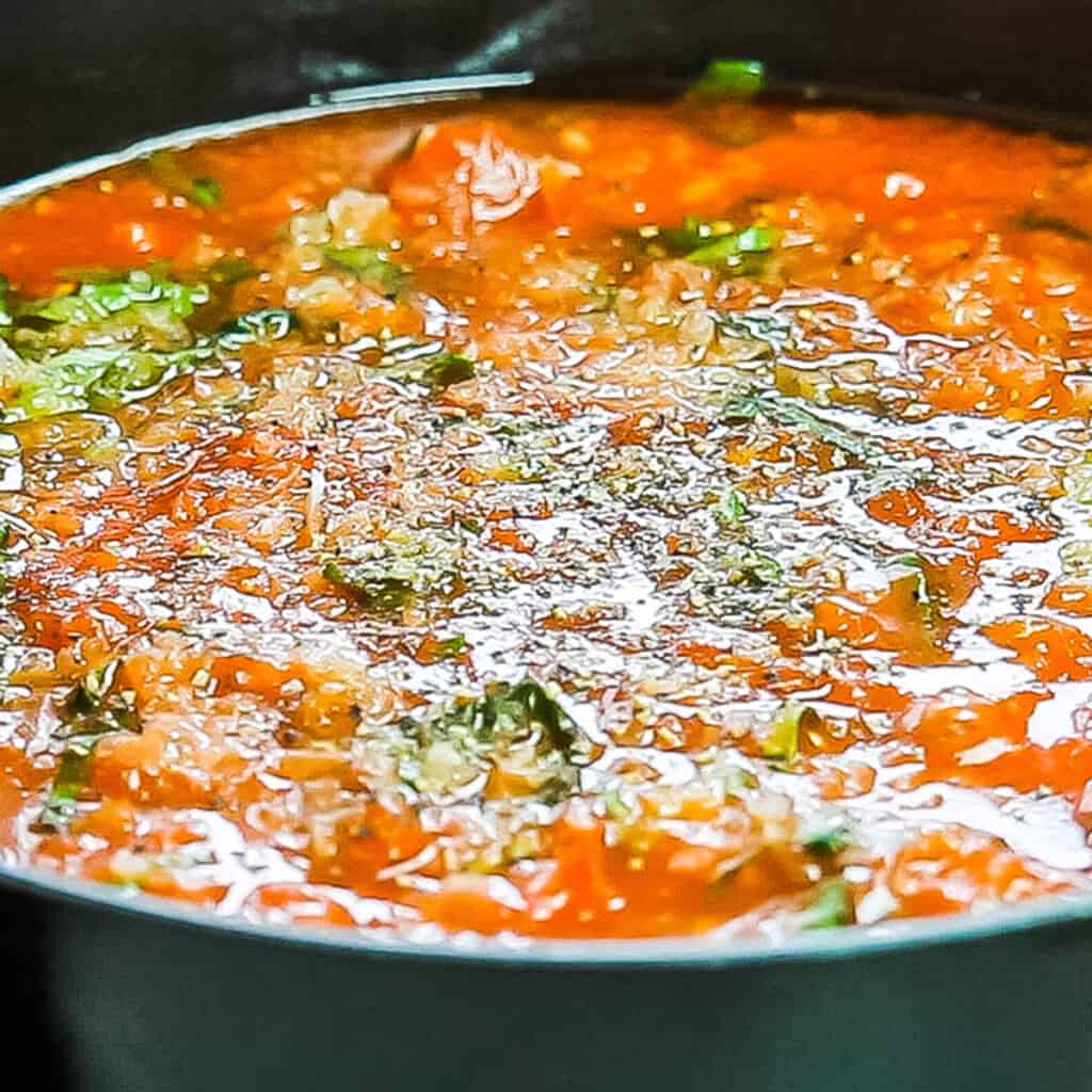 The salt and pepper added to the sauce in the pan