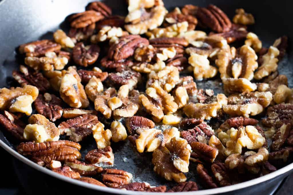 The nuts and salt toasting in the pan