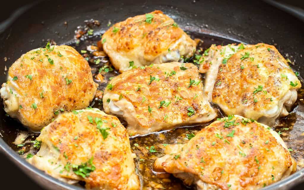 Baked Garlic Chicken Thighs with crispy skin in a pan