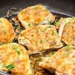 Baked Garlic Chicken Thighs with crispy skin in a pan