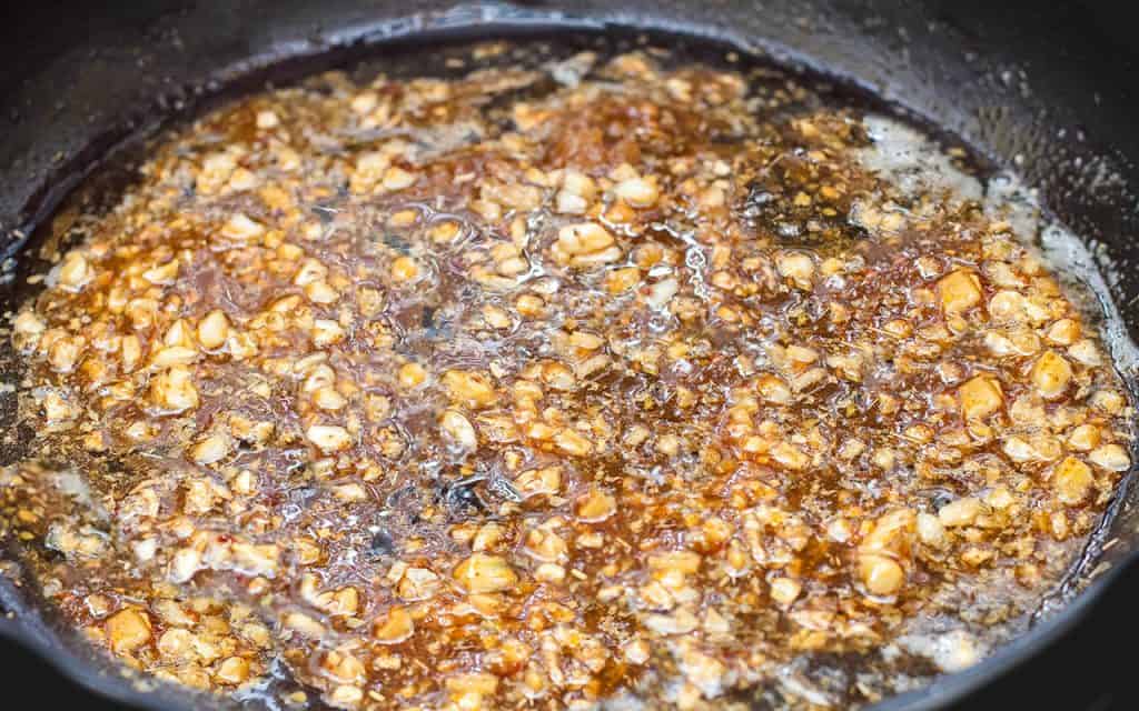 the garlic cooking the wine in the pan