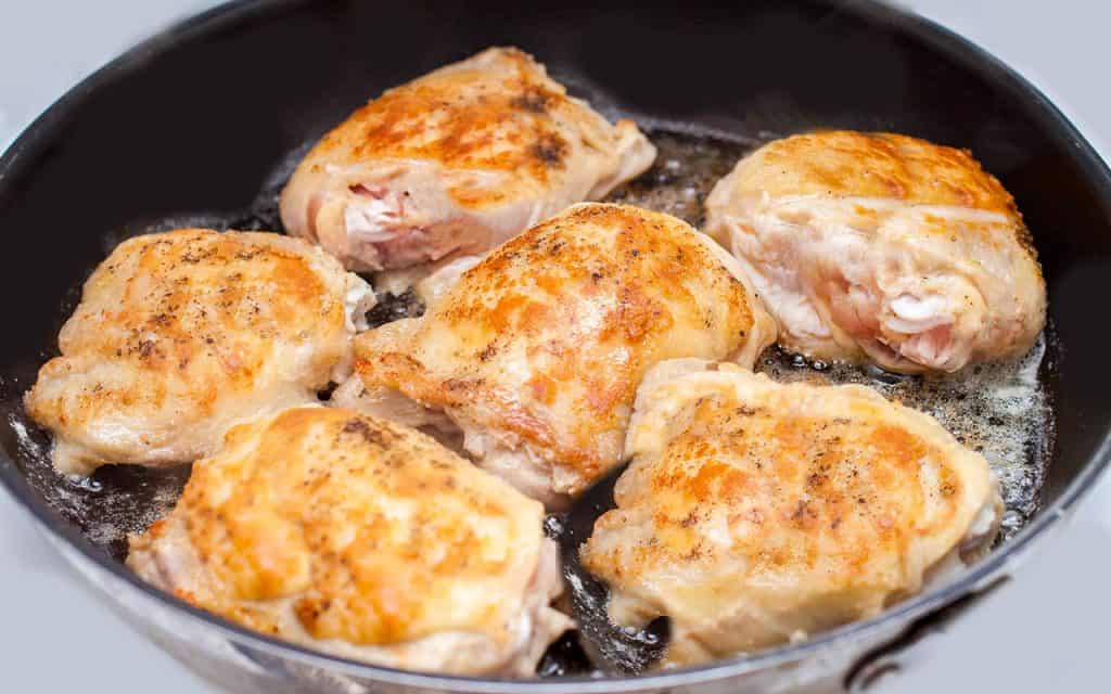 Chicken browning in a pan