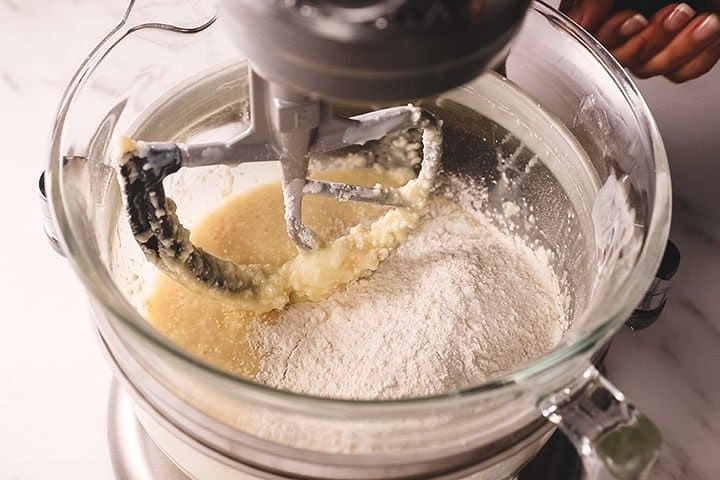 The flour added to the butter mixture in a mixing bowl
