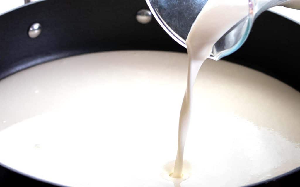 cream being poured into a pot